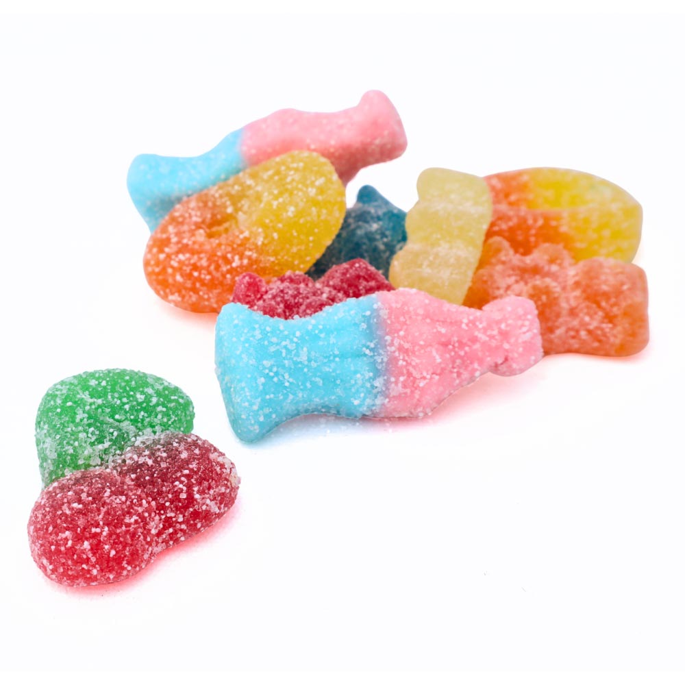 Colourful assorted American Halloween candy bowl with fizzy cherries, peach rings, bears and bubblegum bottles